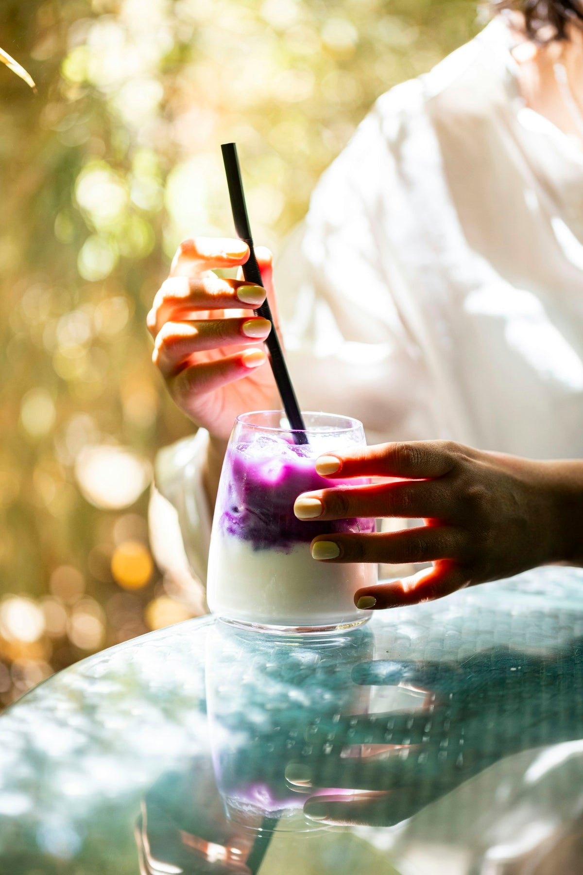 Glass of homemade ube milk, a lilac Filipino-style purple milk drink over ice