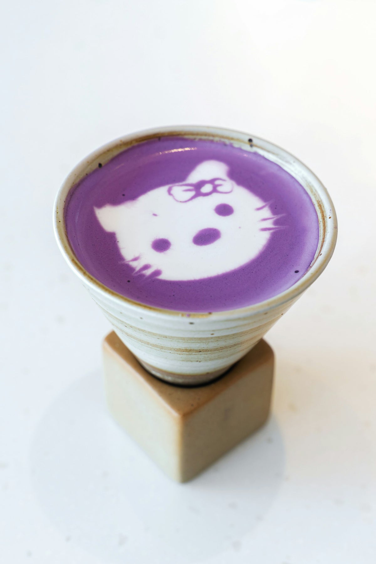 Ube latte in a takeaway cup